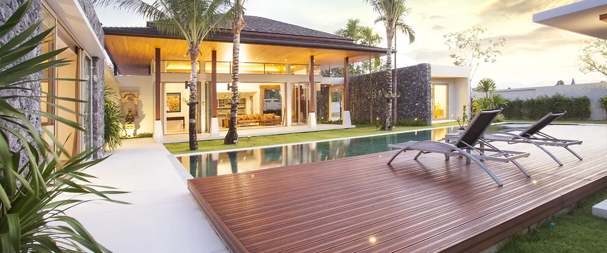 A composite deck near a pool and an expensive home