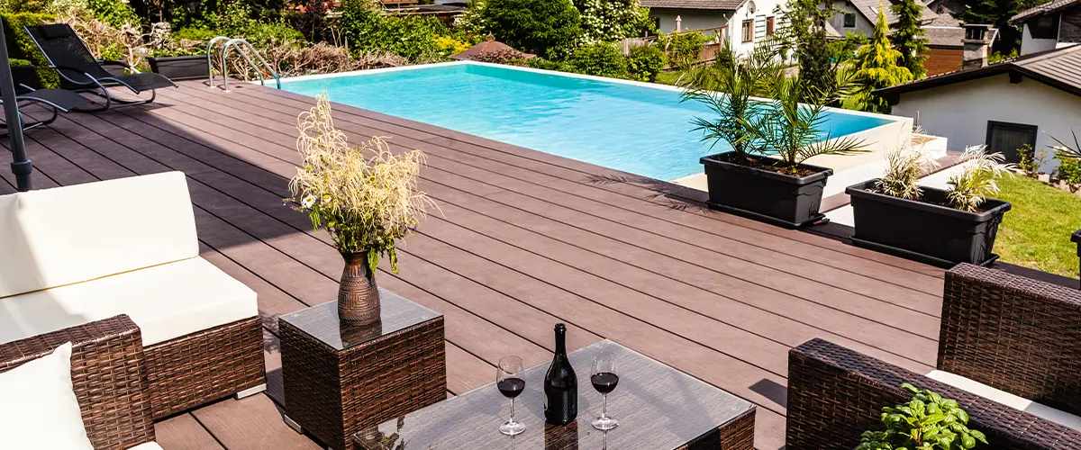 Composite decking around a pool and outdoor furniture