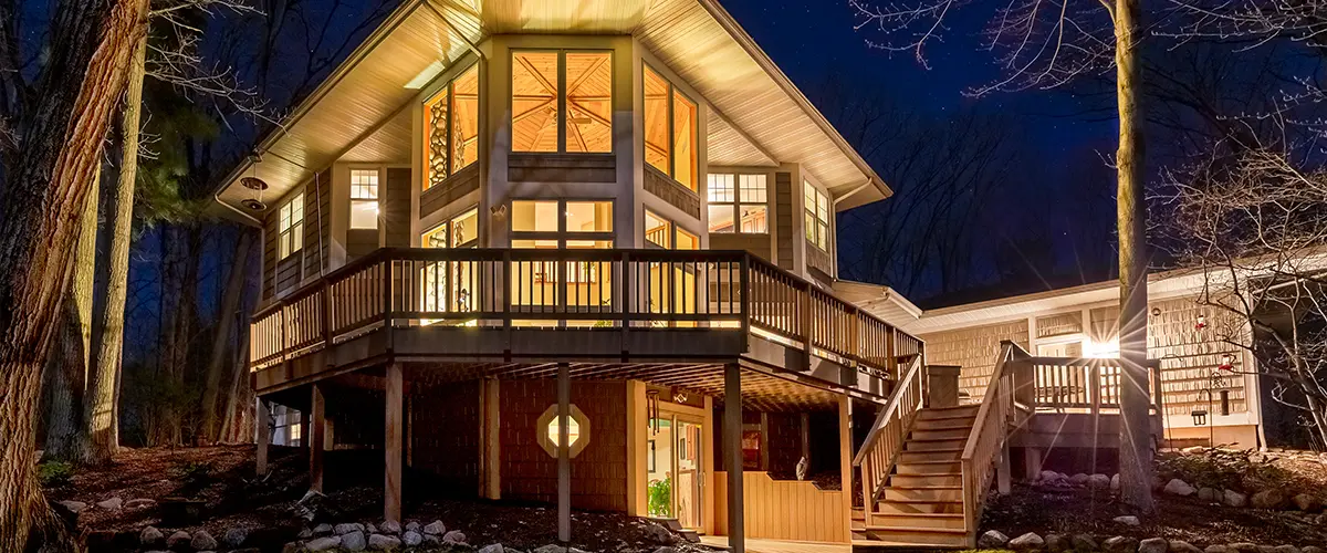 A second story deck with lights at night