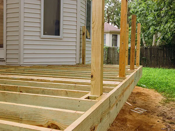 Deck frame with pressure-treated wood and wood posts