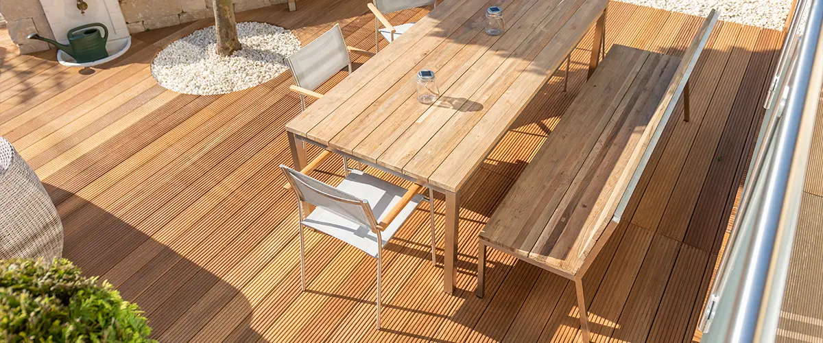 Composite decking with a wood table and a bench