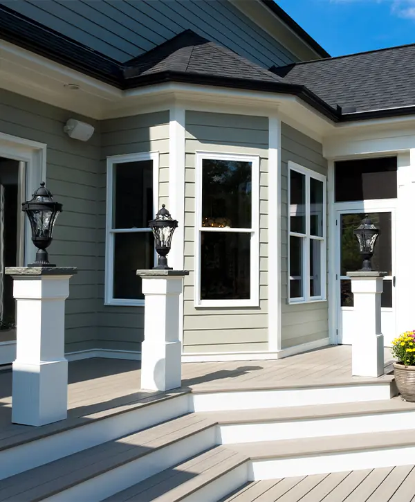 Decking on porch and beautiful lighting fixtures on three columns