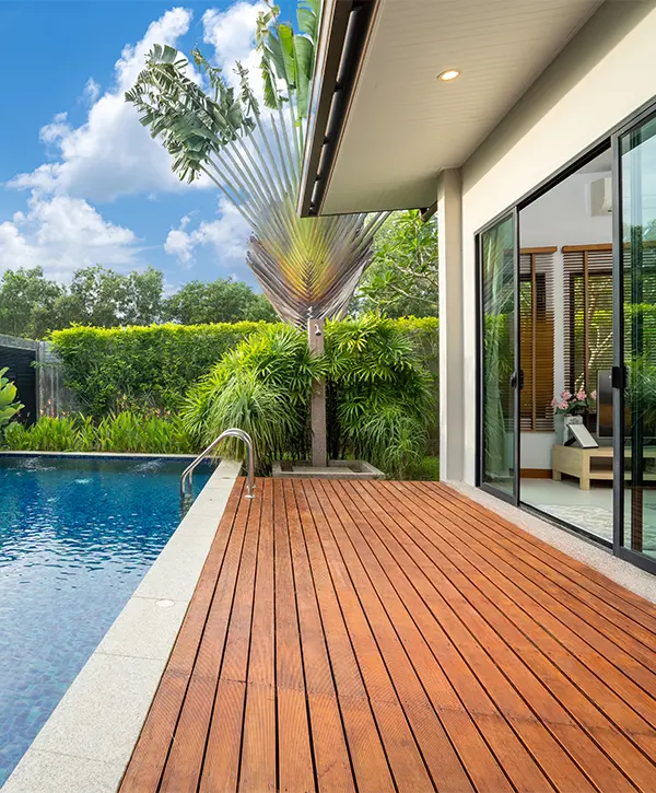Composite decking near a pool and large glass sliding doors