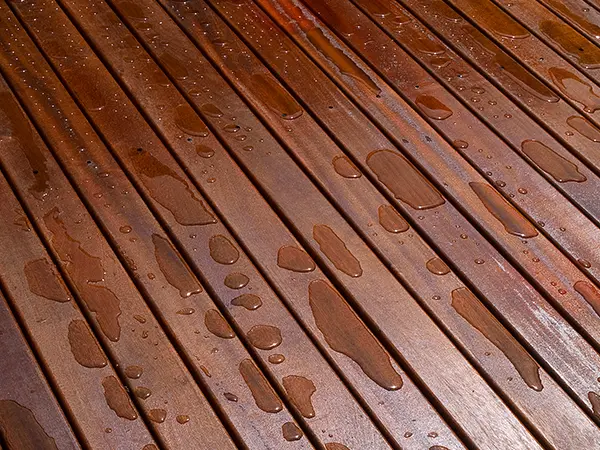 Mahogany wood decking with water droplets on it
