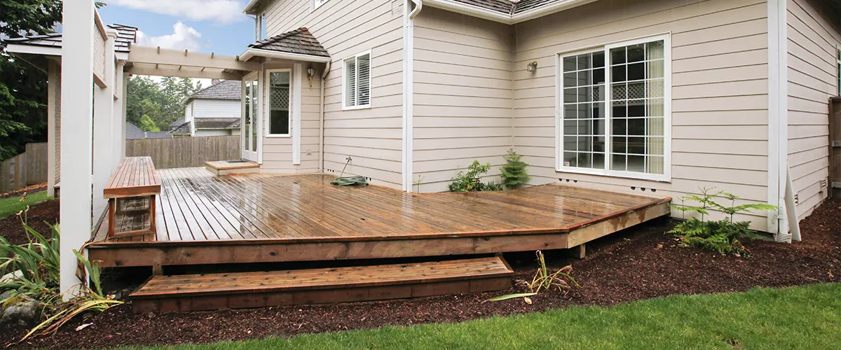 Wet wood decking attached to a home