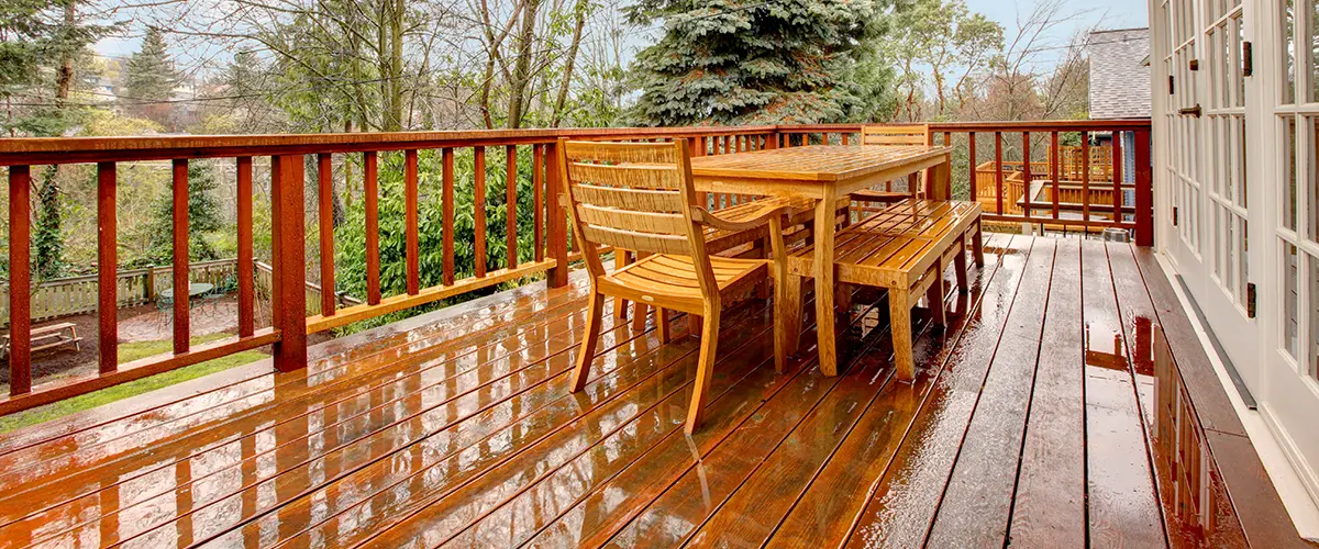 Wet wood deck with table and chairs