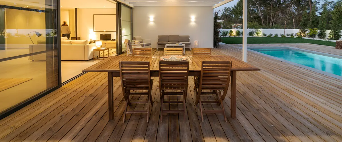 Wood decking with outdoor furniture and a pool