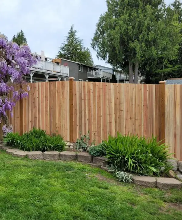 A cedar fence with a lily flower