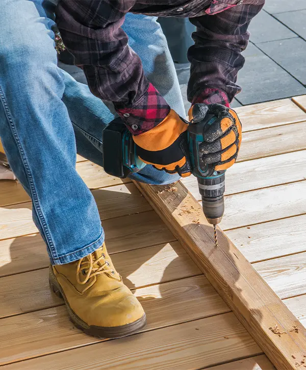 A contractor from one of the best deck building companies in Mill Creek working on building a deck