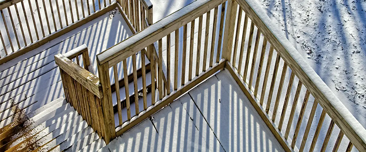 A set of two deck stairs with wood railing