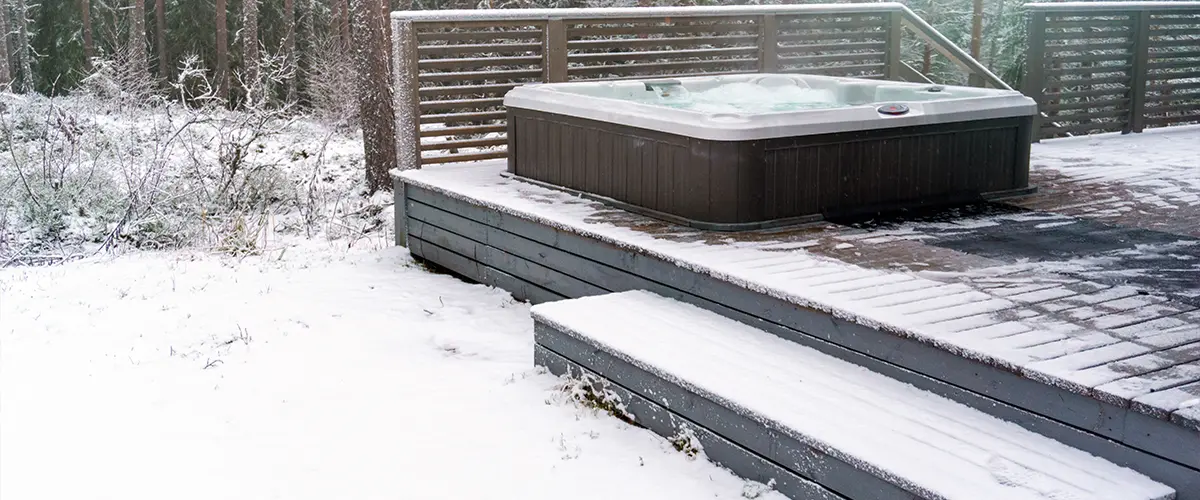 A jacuzzi on a ground-level composite deck with stairs