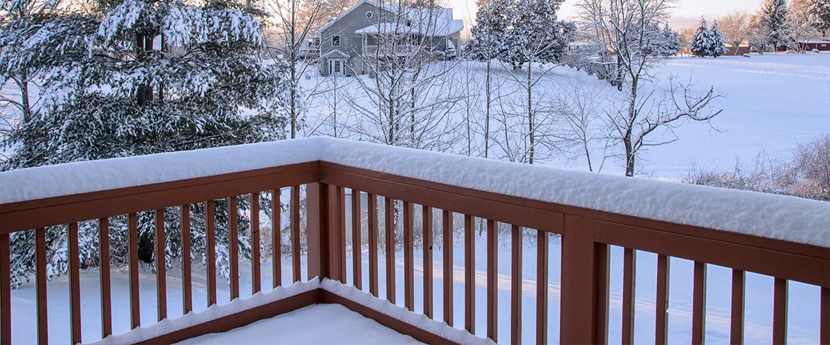 Wood railing with snow on it