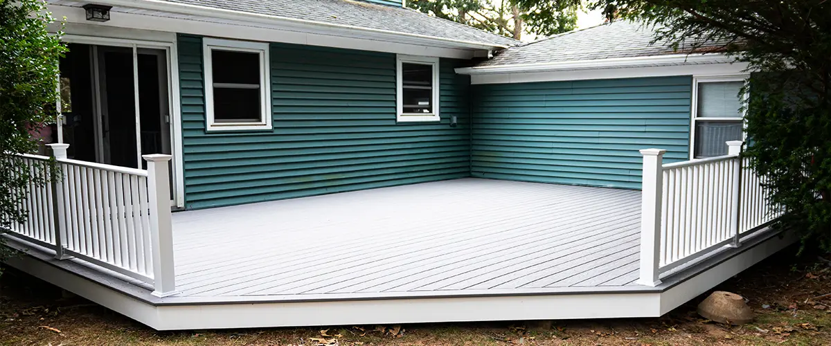 Composite decking with metal railings painted white