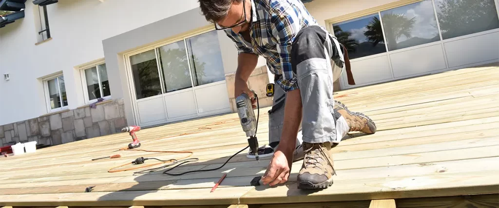 A man doing a deck repair in North Creek, WA