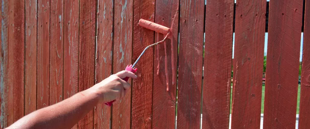 Roller Three Drips Hand rolling waterproofing stain on a fence Seal A Fence To Deal With The WA Weather